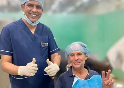 Dental surgeon and a happy patient giving a thumbs up after treatment